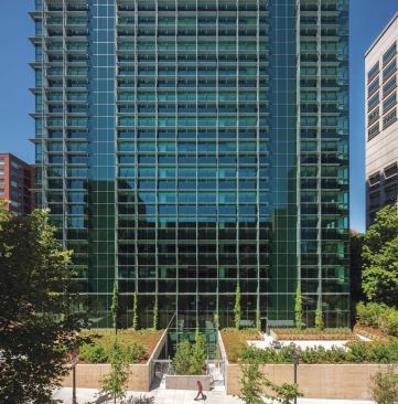 Visitors to the Edith Green–Wendell Wyatt Federal Building enter a double-height lower-level lobby through landscaping that hides the elevation change between the north façade (shown) and south façade. 