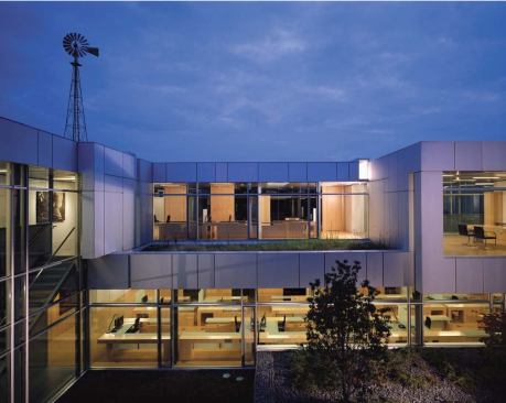 The new offices face either the central courtyard or a restored wetland to the south. The subtle palette of glass and custom light-gray recycled aluminum panels complements the stone of the original Brooks Farm.