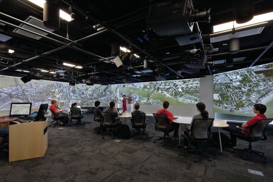 The visualization lab has black box theater lighting grids outfitted with stereoscopic projectors that cast video onto three walls. Adjustable speakers change the sound shape of the room to simulate anything from a concert hall to a forest.