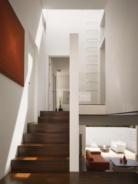 A ship's ladder at the top of stairs provides access to the home's rooftop deck.