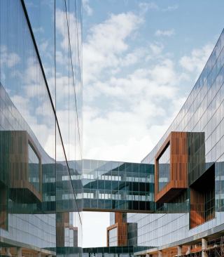 Workspaces are situated near the windows on the perimeter and the interior building's courtyard to maximize daylighting for the workers. 


Curtainwall system - Enclos Corp. - www.enclos.com 

Designed and engineered by specialized contractors - System flexible enough system to accommodate sinuous façade angles - Easily accommodates custom systems without compromising structural integrity


Panelized tongue-and-groove ipe boards - ISEC Inc. - www.isecinc.com 

Cladding system fabricated by specialized contractors - Maintains envelope - Sealed to maintain color and texture of the wood