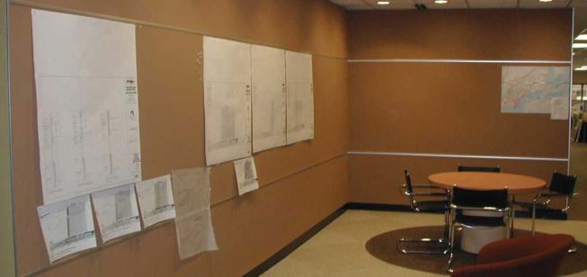 Tac-wall system Walltalkers 
www.walltalkers.com &nbsp;  A durable floor-to-ceiling linoleum and cork wall covering that serves as an alternative to traditional bulletin boards. Available in 12 standard colors, the material resists cracking, drying, and peeling. Color extends throughout the width of the product, better hiding standard wear and tear.
