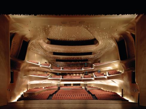 The view from the 3,230-square-foot proscenium stage is dominated by the balconies and by 4,000 LED light fixtures scattered across the ceiling plane. 