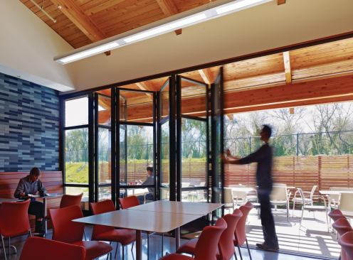 Operable windows throughout the building allow for natural ventilation, and several public areas feature indoor-outdoor space, including this employee dining area.