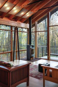 Since heat loss is a concern in the mountain climate, radiant floors and a custom radiator system of stainless steel tubes that run in front of the glazing are supplemented by a wood stove.
