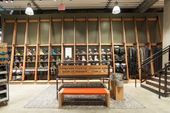 Modeled after a warming hut on a mountainside, the wood armature currently displays ski boots. Come the warmer season, this area will house canoes, kayaks, and paddles.