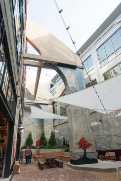 The interior courtyard is the only space where visitors will experience the arena’s full height. Created from a triangular wedge between the arena and the Ice House, the courtyard was hard fought by the design team because, business-wise, it’s a non-selling area. An original flying buttress adds drama to the space while a mural by artist and rock climber Jeremy Collins with muralist Skye Walker celebrates the outdoors with an urban spin using spray paint on concrete. The design team didn’t want to “mimic the activity of where you’re going to go” with faux-realistic landscapes, Shapleigh says. “It’s already in our heads.” Today’s gear stores don’t need stylized “lifestyle photos” for marketing, Dowd says. “That’s what Instagram is for.”