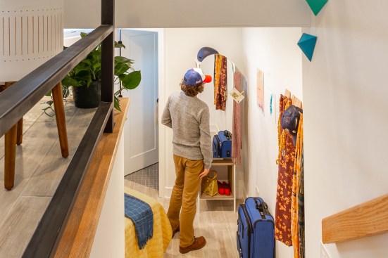 For Stitch, in Chicago’s West Town neighborhood, Via Chicago transformed an angular, 165-square-foot building into a tiny residence. The resulting 325-square-foot house offers a bedroom, a bathroom, and living space organized along a split-level plan.
