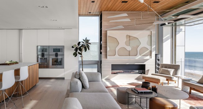 For this Rhode Island house, West Chin used an airport hangar door to create a fourth wall that opened up to the outdoors and the ocean.